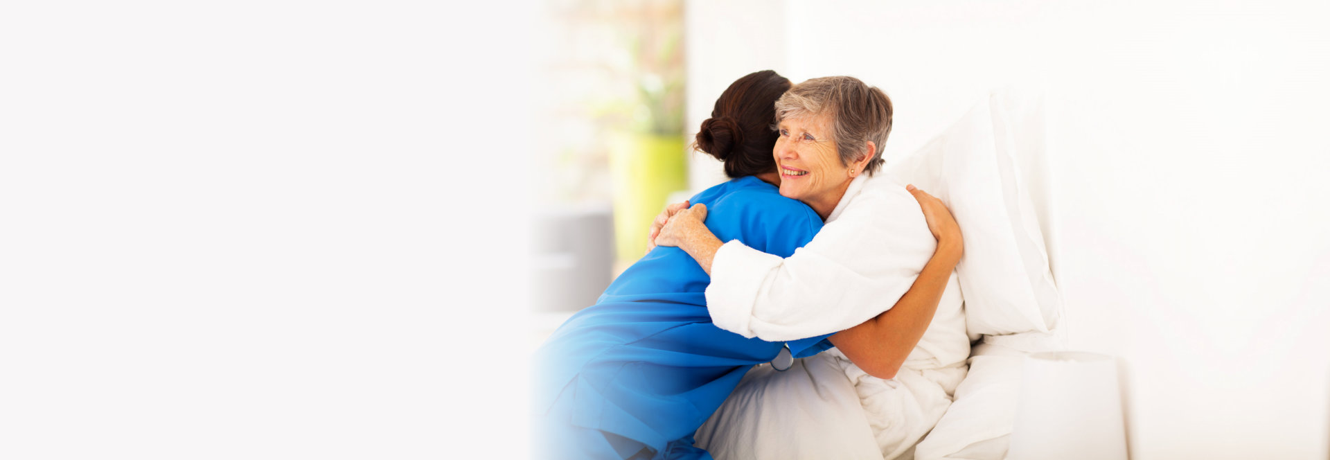 Old woman hugging to caregiver